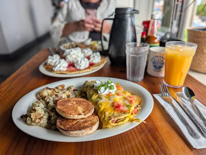Green chile omelet with home fries and English muffins