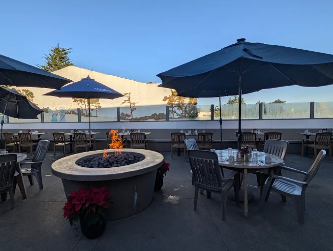 First Awakenings outdoor patio with fire pit at golden hour